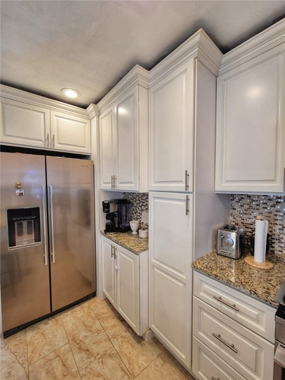 42 Burnside St, Providence, RI 02905 - kitchen featuring stainless steel refrigerator with ice dispenser, decorative backsplash, white cabinetry, light stone counters, and recessed lighting