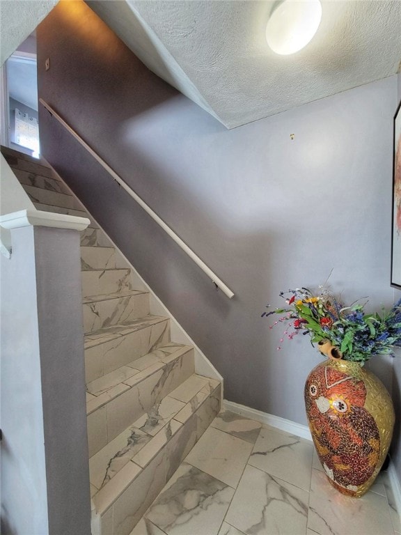 42 Burnside St, Providence, RI 02905 - stairs featuring marble finish flooring and a textured ceiling