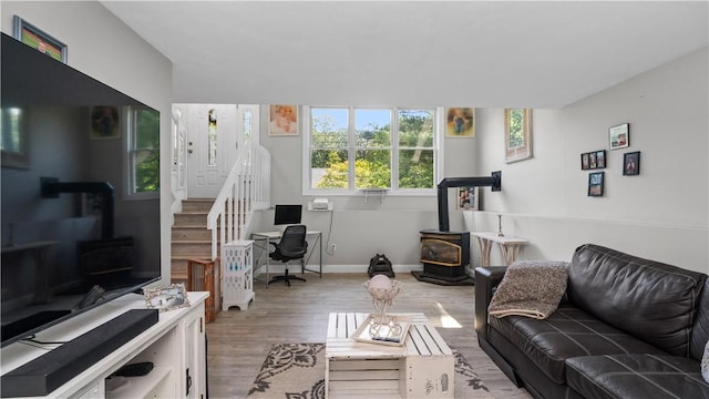 14 Deer Run Dr, Coventry, RI 02816 - living area featuring a wood stove, wood finished floors, and an office area
