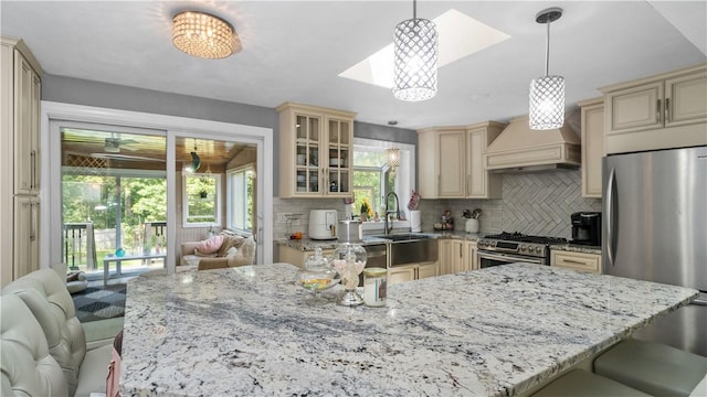 14 Deer Run Dr, Coventry, RI 02816 - kitchen featuring cream cabinets, appliances with stainless steel finishes, custom range hood, decorative backsplash, and light stone countertops