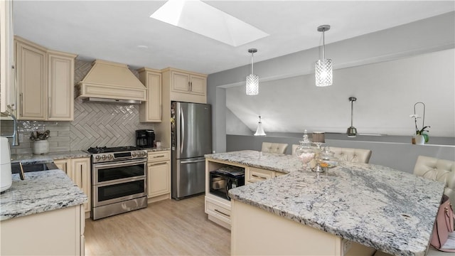 14 Deer Run Dr, Coventry, RI 02816 - kitchen with appliances with stainless steel finishes, cream cabinets, custom exhaust hood, a skylight, and decorative backsplash