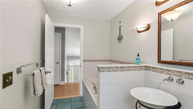 14 Deer Run Dr, Coventry, RI 02816 - full bathroom featuring a bath, tile patterned flooring, a wainscoted wall, and tile walls