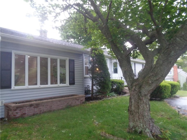 155 Lewiston St, Warwick, RI 02889 - view of home's exterior featuring a lawn and a chimney