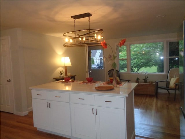 155 Lewiston St, Warwick, RI 02889 - kitchen featuring wood finished floors, white cabinets, light countertops, a chandelier, and a center island