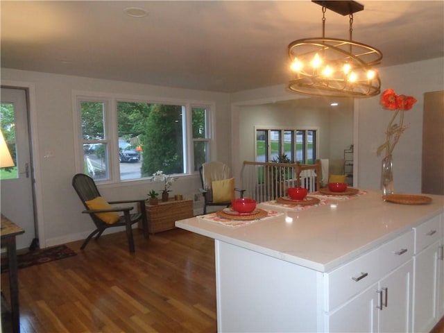 155 Lewiston St, Warwick, RI 02889 - kitchen with dark wood-type flooring, a chandelier, plenty of natural light, and white cabinetry