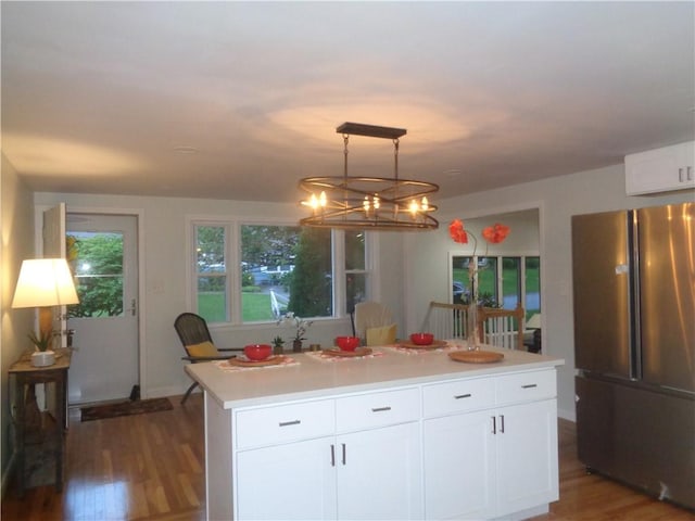 155 Lewiston St, Warwick, RI 02889 - kitchen with freestanding refrigerator, wood finished floors, a chandelier, white cabinets, and light countertops