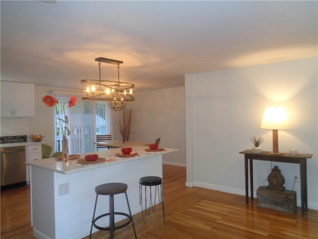 155 Lewiston St, Warwick, RI 02889 - kitchen with wood finished floors, white cabinetry, stainless steel dishwasher, and light countertops