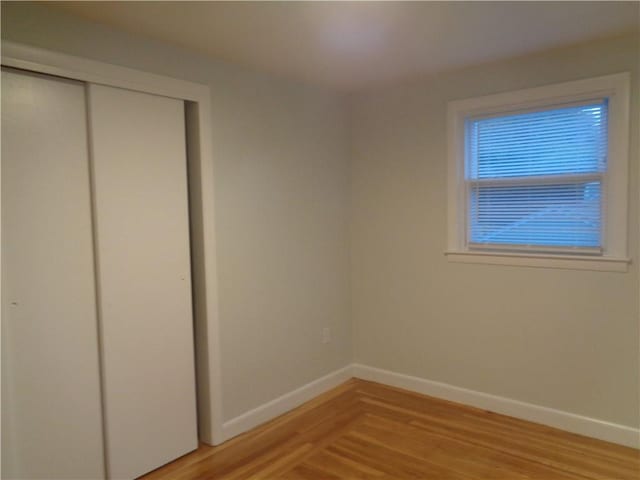 155 Lewiston St, Warwick, RI 02889 - unfurnished bedroom with light wood-style floors, a closet, and elevator