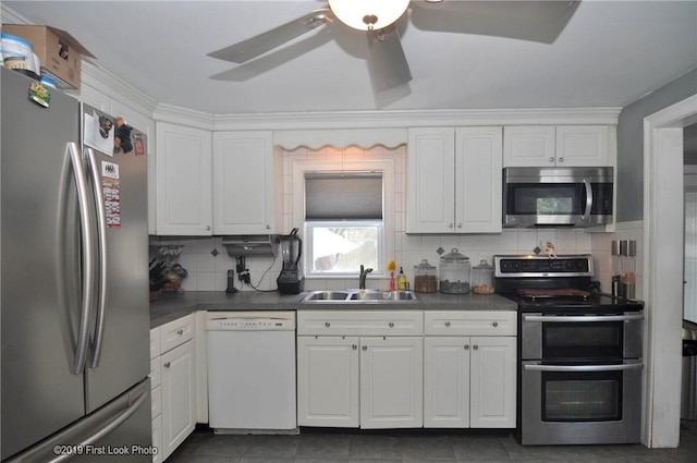 62 Stone Ave, Warwick, RI 02889 - kitchen with stainless steel appliances, decorative backsplash, white cabinetry, and dark countertops