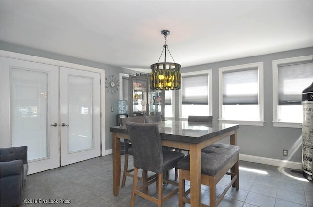 62 Stone Ave, Warwick, RI 02889 - dining room featuring french doors, a chandelier, and tile patterned flooring