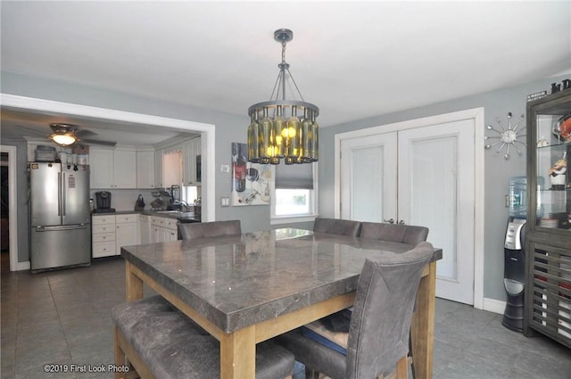 62 Stone Ave, Warwick, RI 02889 - dining room with dark tile patterned floors, a chandelier, and ceiling fan