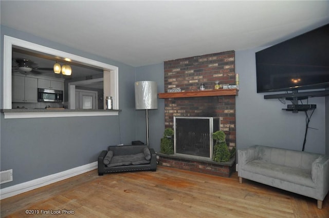 62 Stone Ave, Warwick, RI 02889 - living room with wood finished floors and a fireplace