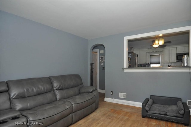 62 Stone Ave, Warwick, RI 02889 - living area with arched walkways and wood finished floors