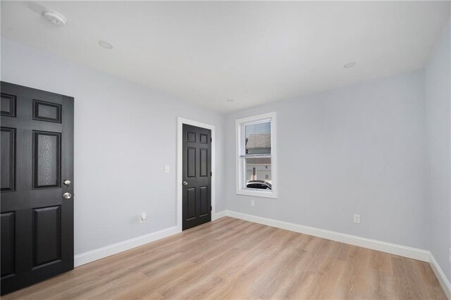 312 Veazie St, Providence, RI 02904 - empty room with light wood-type flooring and a smoke detector