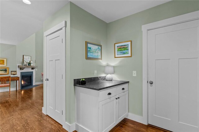 83 Silas Hill Way, Exeter, RI 02822 - bar area with dark wood-style floors and a lit fireplace