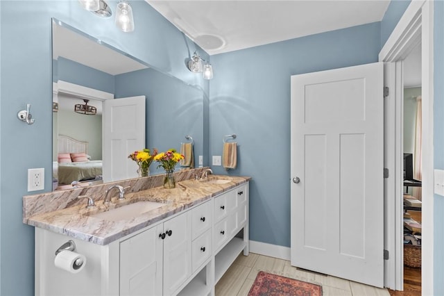 83 Silas Hill Way, Exeter, RI 02822 - ensuite bathroom featuring double vanity and baseboards