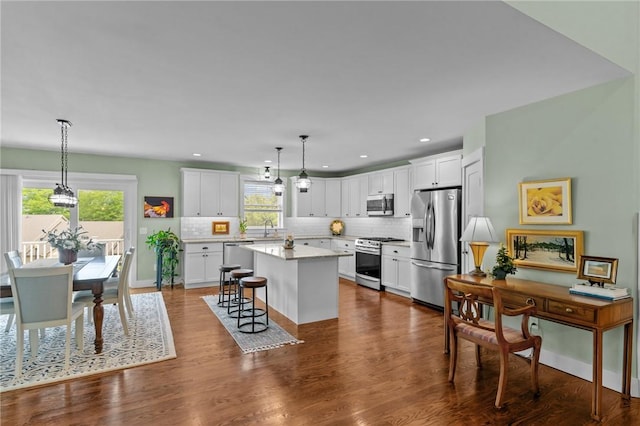 83 Silas Hill Way, Exeter, RI 02822 - kitchen featuring stainless steel appliances, backsplash, a center island, white cabinetry, and recessed lighting