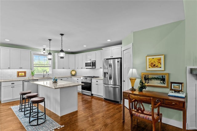 83 Silas Hill Way, Exeter, RI 02822 - kitchen featuring stainless steel appliances, decorative backsplash, a breakfast bar, a center island, and recessed lighting