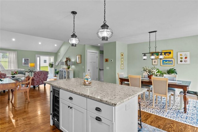 83 Silas Hill Way, Exeter, RI 02822 - kitchen featuring wine cooler, wood finished floors, a center island, white cabinets, and open floor plan