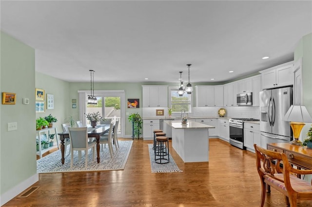 83 Silas Hill Way, Exeter, RI 02822 - kitchen featuring appliances with stainless steel finishes, healthy amount of natural light, a center island, decorative backsplash, and recessed lighting