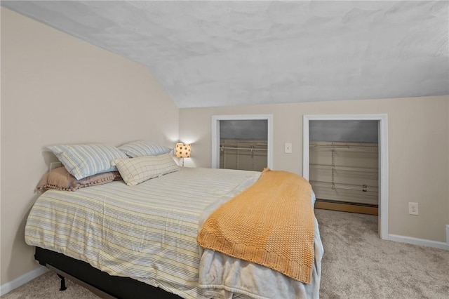 273 Main St, Cranston, RI 02823 - bedroom with carpet, vaulted ceiling, a baseboard radiator, and a walk in closet