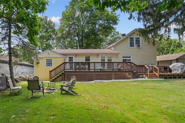 273 Main St, Cranston, RI 02823 - rear view of house featuring a fire pit, a deck, a lawn, and stairway