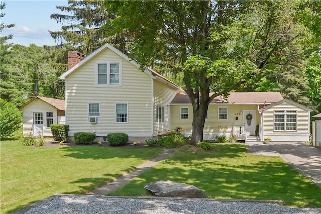 273 Main St, Cranston, RI 02823 - traditional-style home featuring a chimney, a front yard, and an outbuilding