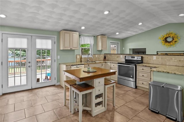 273 Main St, Cranston, RI 02823 - kitchen with stainless steel range with electric cooktop, a breakfast bar area, recessed lighting, french doors, and light tile patterned floors