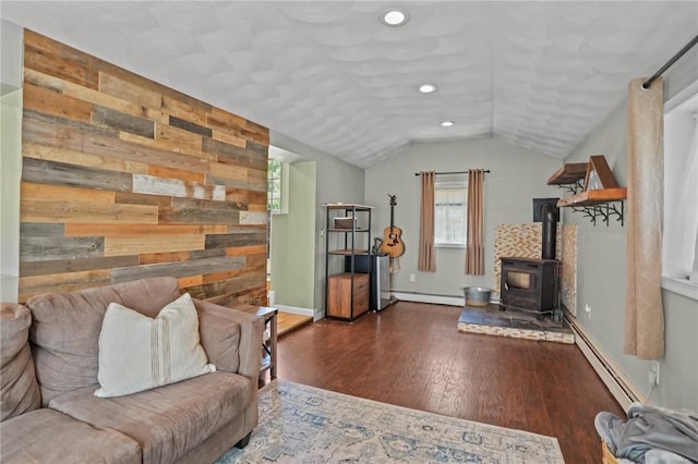 273 Main St, Cranston, RI 02823 - living room with a baseboard heating unit, a wood stove, wooden walls, wood finished floors, and lofted ceiling