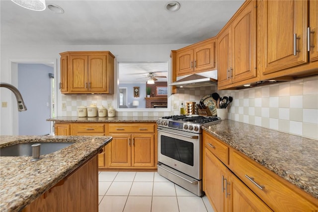34 Finch Ln, North Kingstown, RI 02874 - kitchen with stainless steel gas stove, brown cabinets, and under cabinet range hood