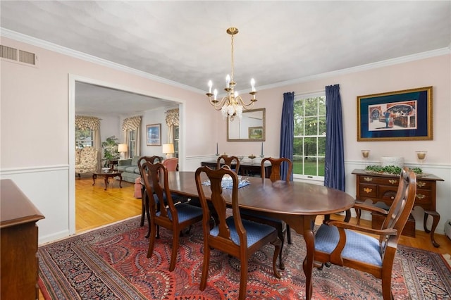 34 Finch Ln, North Kingstown, RI 02874 - dining area with a chandelier, wood finished floors, and ornamental molding