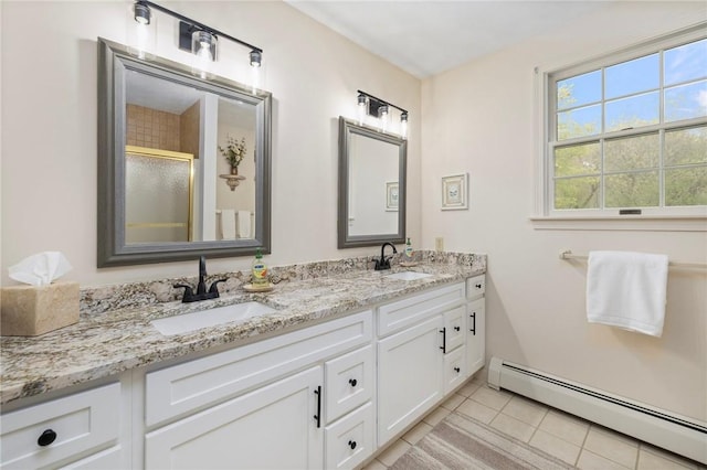 34 Finch Ln, North Kingstown, RI 02874 - full bathroom with baseboard heating, double vanity, tile patterned floors, and a shower with shower door