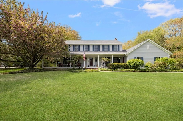 34 Finch Ln, North Kingstown, RI 02874 - colonial house with a porch, a front yard, and a chimney