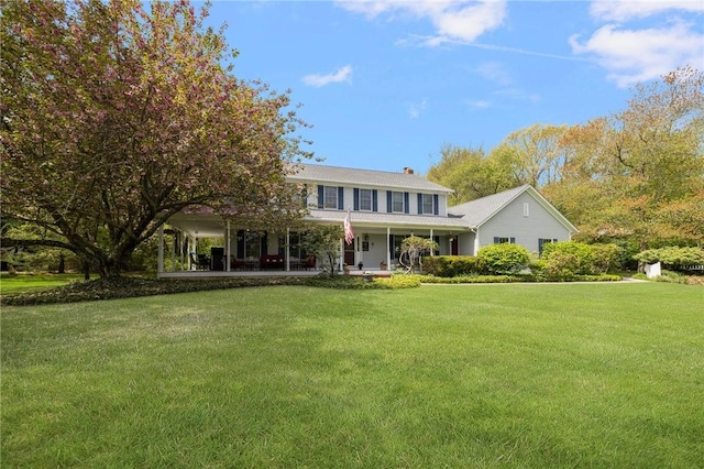 34 Finch Ln, North Kingstown, RI 02874 - view of front of property featuring a front yard, a porch, and a chimney