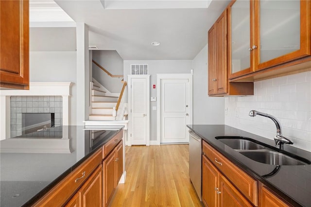 279 Benefit St Unit 3, Providence, RI 02903 - kitchen featuring brown cabinets, light wood-type flooring, and decorative backsplash