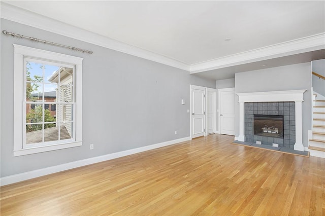 279 Benefit St Unit 3, Providence, RI 02903 - unfurnished living room featuring light wood-style floors, ornamental molding, a fireplace, and stairs