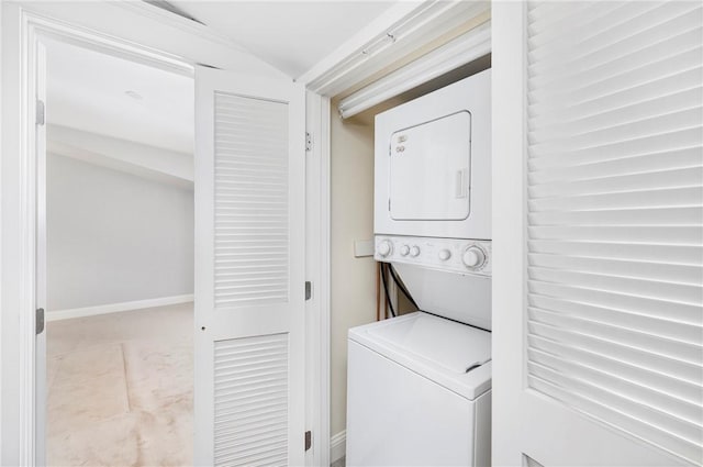 279 Benefit St Unit 3, Providence, RI 02903 - laundry area with stacked washer and clothes dryer and baseboards