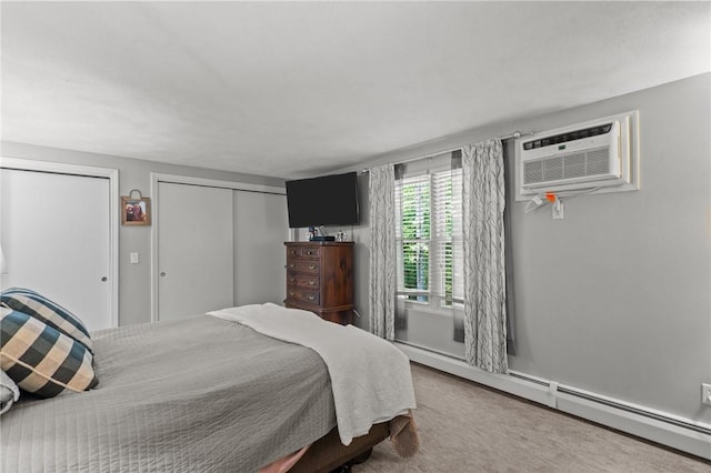 47 Pheasant Run Unit A, Smithfield, RI 02917 - carpeted bedroom featuring a baseboard radiator, multiple closets, and a wall mounted air conditioner