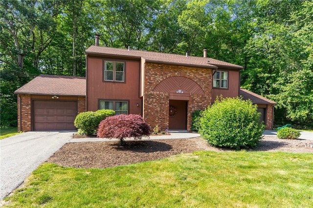 47 Pheasant Run Unit A, Smithfield, RI 02917 - view of front of property featuring a garage, driveway, a front lawn, and brick siding
