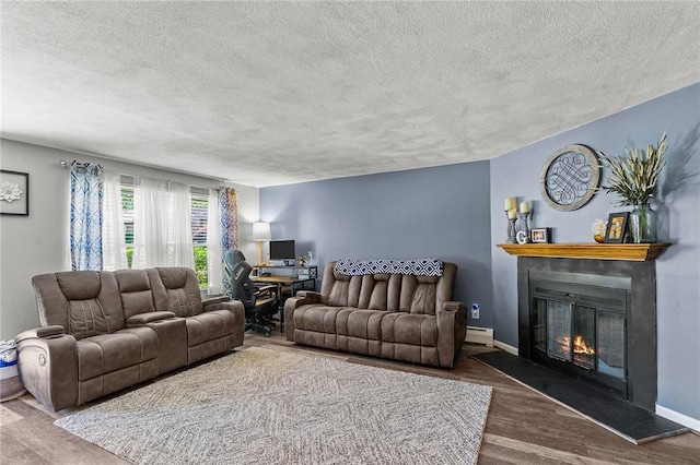 47 Pheasant Run Unit A, Smithfield, RI 02917 - living area with a textured ceiling, a glass covered fireplace, a baseboard heating unit, an office area, and wood finished floors