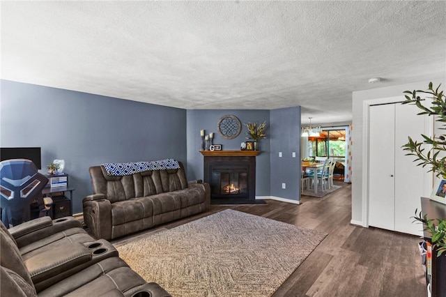 47 Pheasant Run Unit A, Smithfield, RI 02917 - living area with wood finished floors, a textured ceiling, and a fireplace with flush hearth