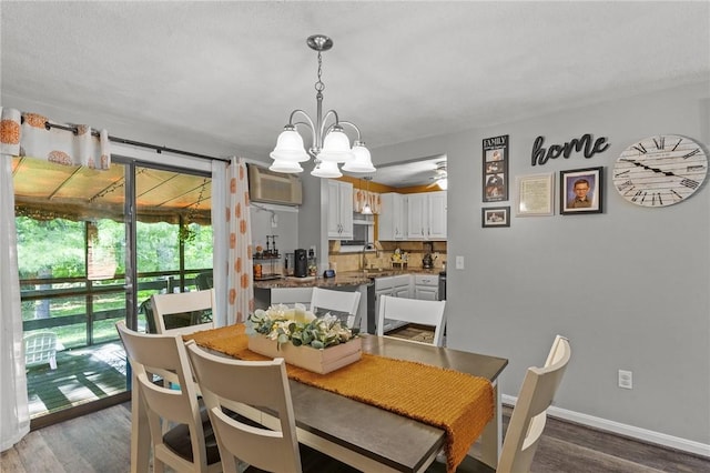 47 Pheasant Run Unit A, Smithfield, RI 02917 - dining area featuring wood finished floors, a wall mounted AC, a chandelier, and a ceiling fan