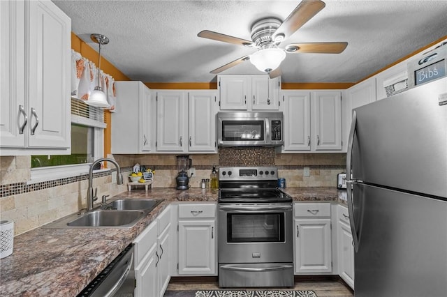 47 Pheasant Run Unit A, Smithfield, RI 02917 - kitchen with appliances with stainless steel finishes, white cabinetry, ceiling fan, tasteful backsplash, and a textured ceiling