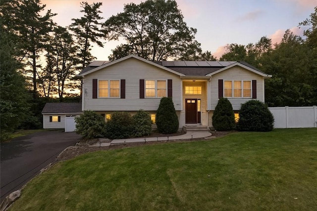 1060 Joslin Rd, Burrillville, RI 02830 - bi-level home with roof mounted solar panels, asphalt driveway, and a garage