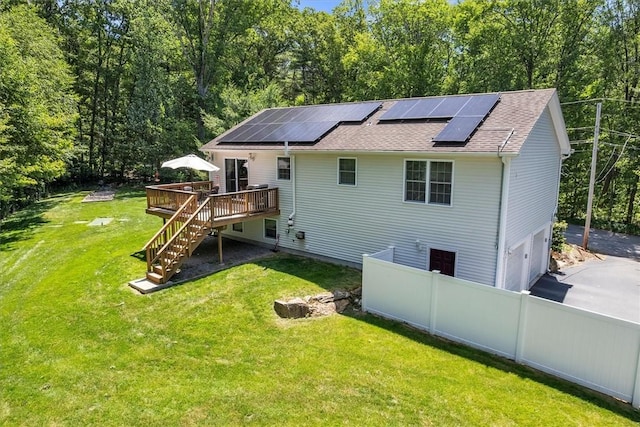 1060 Joslin Rd, Burrillville, RI 02830 - back of property with a wooden deck, stairs, a shingled roof, solar panels, and a garage