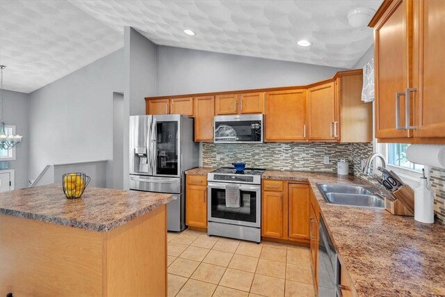1060 Joslin Rd, Burrillville, RI 02830 - kitchen with stainless steel appliances, vaulted ceiling, a chandelier, decorative backsplash, and light tile patterned floors