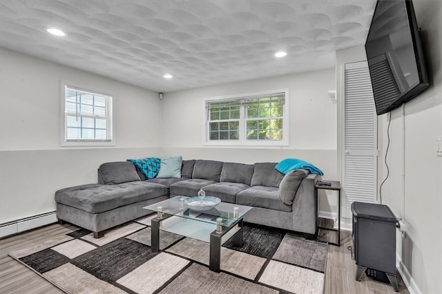 1060 Joslin Rd, Burrillville, RI 02830 - living area with plenty of natural light, wood finished floors, recessed lighting, and baseboard heating