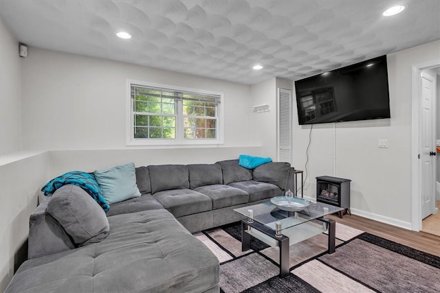 1060 Joslin Rd, Burrillville, RI 02830 - living area with wood finished floors, a wood stove, and recessed lighting