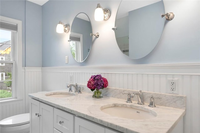 1 Slocum St, Newport, RI 02840 - bathroom featuring a wainscoted wall, double vanity, and plenty of natural light