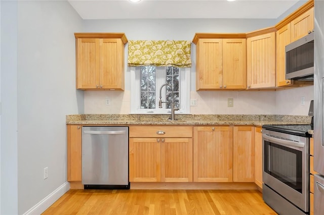1 Slocum St, Newport, RI 02840 - kitchen featuring stainless steel appliances, light wood-style floors, light brown cabinetry, and light stone countertops